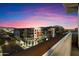 A vibrant sunset illuminates this contemporary building featuring pool and city views at 15802 N 71St St # 754, Scottsdale, AZ 85254