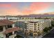 Modern apartment complex with mountain views under a colorful sunset sky at 15802 N 71St St # 754, Scottsdale, AZ 85254