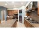 Elegant kitchen with stainless appliances, granite counters, and island with cooktop at 15802 N 71St St # 754, Scottsdale, AZ 85254