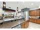 Well-appointed kitchen with stone countertops, tile flooring, stainless steel appliances, and breakfast bar at 15802 N 71St St # 754, Scottsdale, AZ 85254