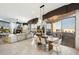Open-concept living space with a fireplace, dining area, and balcony access with scenic views at 15802 N 71St St # 754, Scottsdale, AZ 85254