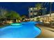Community pool area with a hot tub, palm trees, and luxurious lounge chairs at 15802 N 71St St # 754, Scottsdale, AZ 85254