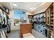 A spacious walk-in closet features custom shelving, and a lovely window offering views of the landscape at 15802 N 71St St # 754, Scottsdale, AZ 85254
