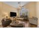 Spacious living room bathed in natural light, featuring hardwood floors and comfortable seating arrangements at 16044 S 24Th Pl, Phoenix, AZ 85048