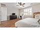 Bedroom with wood floors and ceiling fan, featuring dresser and vanity table at 16658 W Mescal St, Surprise, AZ 85388