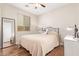 This bright bedroom features wood-look floors, a large window, and an accent mirror at 16658 W Mescal St, Surprise, AZ 85388