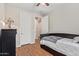 Cozy bedroom with wood-look floors, a comfortable bed, and white paneled doors at 16658 W Mescal St, Surprise, AZ 85388