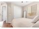 Bedroom with wood-look floors featuring a sliding-door closet and bright window at 16658 W Mescal St, Surprise, AZ 85388