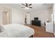 Bedroom with wood floors and ceiling fan; view of dresser, vanity, and doorway at 16658 W Mescal St, Surprise, AZ 85388
