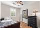 Charming bedroom features a bed, stylish dresser, and window with plantation shutters at 16658 W Mescal St, Surprise, AZ 85388