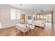 Dining area featuring a glass table, upholstered chairs, and sliding glass doors to the backyard at 16658 W Mescal St, Surprise, AZ 85388