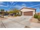 Charming single-story home with a two-car garage, desert landscaping, and a well-maintained front yard at 16658 W Mescal St, Surprise, AZ 85388