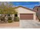 Charming single-story home with a two-car garage, desert landscaping, and a well-maintained front yard at 16658 W Mescal St, Surprise, AZ 85388