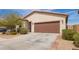 Charming single-story home with a two-car garage, desert landscaping, and a well-maintained front yard at 16658 W Mescal St, Surprise, AZ 85388
