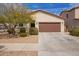 Charming single-story home with a two-car garage, desert landscaping, and a well-maintained front yard at 16658 W Mescal St, Surprise, AZ 85388