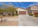 Charming single-story home with a two-car garage, desert landscaping, and a well-maintained front yard at 16658 W Mescal St, Surprise, AZ 85388