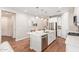 Bright kitchen with white cabinets, stainless steel appliances, and kitchen island with seating at 16658 W Mescal St, Surprise, AZ 85388