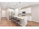 Bright kitchen with white cabinets, stainless steel appliances, island with seating and pendant lighting at 16658 W Mescal St, Surprise, AZ 85388