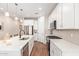 Bright kitchen with white cabinets, stainless steel appliances, and a large island at 16658 W Mescal St, Surprise, AZ 85388