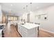 Open-concept kitchen featuring a kitchen island, pendant lights, and view into the living room at 16658 W Mescal St, Surprise, AZ 85388