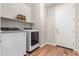 Bright laundry room features new washer and dryer, shelves and access to the garage at 16658 W Mescal St, Surprise, AZ 85388