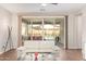 Open living room with sliding glass doors leading to a patio with backyard views at 16658 W Mescal St, Surprise, AZ 85388