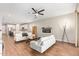 Bright living room with modern fireplace, ceiling fan, wood flooring and stylish white sofas at 16658 W Mescal St, Surprise, AZ 85388