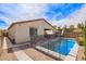 Backyard features a pool with lounge chairs and landscaped surroundings, ready for enjoyment at 16658 W Mescal St, Surprise, AZ 85388