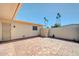 Private brick-paved backyard with stucco walls and desert landscaping, perfect for relaxation at 17022 N Pinion Ln, Sun City, AZ 85373