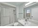 Bathroom featuring shower, toilet, vanity with mirror, and modern light-colored hard surface floors at 17022 N Pinion Ln, Sun City, AZ 85373