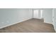 Bright bedroom with light blue walls, light wood-look floors, and sliding door at 17022 N Pinion Ln, Sun City, AZ 85373