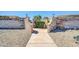 Landscaped entrance to Royal Court featuring brick columns and gravel at 17022 N Pinion Ln, Sun City, AZ 85373