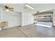 Bright garage with built-in storage cabinets, a utility sink, and an automatic garage door at 17022 N Pinion Ln, Sun City, AZ 85373