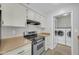 Kitchen featuring a stainless steel stove and access to the laundry room at 17022 N Pinion Ln, Sun City, AZ 85373