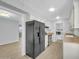 Bright kitchen featuring stainless steel refrigerator and laundry room access at 17022 N Pinion Ln, Sun City, AZ 85373