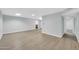 Spacious living room with wood floors, a ceiling fan, and multiple entry points at 17022 N Pinion Ln, Sun City, AZ 85373