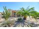 Landscaped backyard with desert plants, gravel, patio, and covered sitting area at 19212 N Tallowood Way, Surprise, AZ 85387