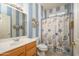 Nautical-themed bathroom with blue and white walls and a shower with a decorative curtain at 19212 N Tallowood Way, Surprise, AZ 85387