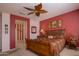 Comfortable bedroom with ample natural light, dark furniture, and decorative ceiling fan at 19212 N Tallowood Way, Surprise, AZ 85387