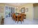 Bright dining area featuring a wooden table and seating for eight, bathed in natural light at 19212 N Tallowood Way, Surprise, AZ 85387