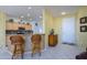 View of home's entrance including kitchen bar with granite countertops and modern appliances at 19212 N Tallowood Way, Surprise, AZ 85387