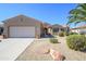 Charming single-story home featuring desert landscaping, a two-car garage, and a tile roof at 19212 N Tallowood Way, Surprise, AZ 85387