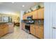 Well-lit kitchen features stainless appliances, granite counters, and ample cabinet space at 19212 N Tallowood Way, Surprise, AZ 85387