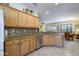 Sun-filled kitchen featuring granite countertops, mosaic backsplash, and stainless steel dishwasher at 19212 N Tallowood Way, Surprise, AZ 85387