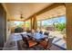 Covered patio with an outdoor dining set, offering a relaxing space with views of the backyard at 19212 N Tallowood Way, Surprise, AZ 85387