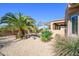 A well-kept backyard is landscaped with rocks and desert foliage at 19212 N Tallowood Way, Surprise, AZ 85387