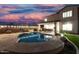 Inviting backyard featuring a sparkling pool, covered patio, manicured landscaping and charming perimeter lighting at 2046 E Avenida Del Sol --, Phoenix, AZ 85024