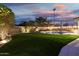Lush backyard with artificial grass, inground pool, and a patio at 2046 E Avenida Del Sol --, Phoenix, AZ 85024