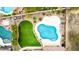 Aerial view of a backyard showcasing a swimming pool, vibrant green lawn, desert landscaping, and privacy fence at 2046 E Avenida Del Sol --, Phoenix, AZ 85024