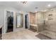 This bathroom has a walk-in closet and walk-in shower with neutral tile and a glass shower door at 2046 E Avenida Del Sol --, Phoenix, AZ 85024